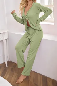 Detailed view of women's sage green ribbed knit lounge set featuring tie-front cardigan