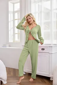 Full view of woman wearing sage green tie-front loungewear set in sunlit bedroom