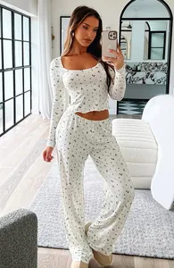 Full length view of a woman wearing a white floral two-piece loungewear set