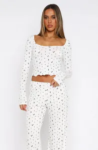 Floral pajama set featuring long sleeve crop top and high waist pants in white