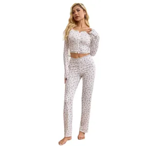 Women's two-piece floral print pajama set with lace trim cardigan top and long pants.