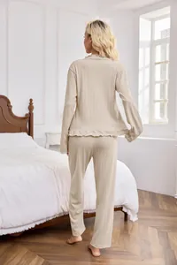 Back view of beige textured long-sleeve pajama set for women shown in a cozy bedroom