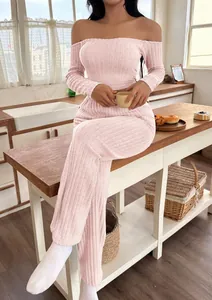 Detail view of pink off-shoulder ribbed loungewear set in a cozy kitchen setting