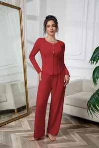 Detailed view of red ribbed long-sleeve loungewear set on a model in a cozy room