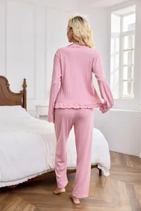 Back view of a pink two-piece women's pajama set featuring waffle knit texture.