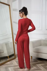 Rear view of a model wearing a comfortable red ribbed two-piece pajama set in a lounge
