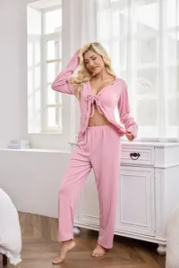 Detail of a pink textured knit pajama set with tie-front cardigan and matching pants.