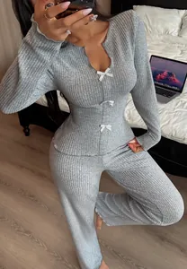 Close-up of grey ribbed knit pajama set featuring delicate bow details and V-neck