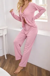 Detailed shot of a pink tie-front pajama set featuring soft textured waffle knit fabric.
