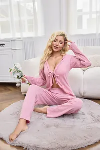 Close-up detail of pink sexy tie-front cardigan and matching pajama pants set for women.