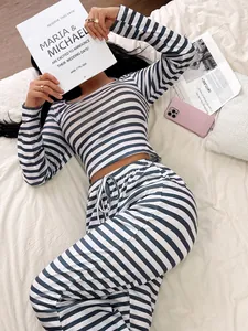 Cozy two-piece blue and white striped pajama set shown in a stylish home setting