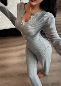Close-up of grey V-neck knitted loungewear set featuring delicate white bow decorations.