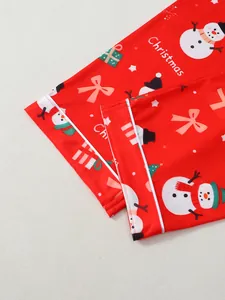 Gros plan du pantalon de pyjama de Noël rouge avec motifs de bonhomme de neige et liseré