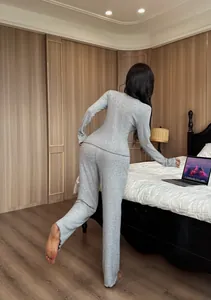 Detailed back view of a grey ribbed knitted two-piece loungewear set in a cozy bedroom