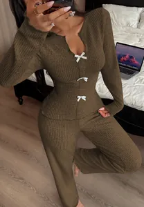 Detail view of the brown ribbed knit loungewear set with elegant white bow accents on top