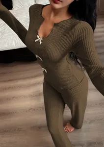 Detailed view of women's brown ribbed knit pajama set featuring V-neck and white bows