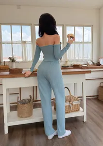 Back view of light blue off-shoulder ribbed loungewear set in a cozy kitchen setting.