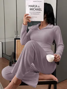 Model wearing purple ribbed polo neck long sleeve loungewear set while relaxing indoors.