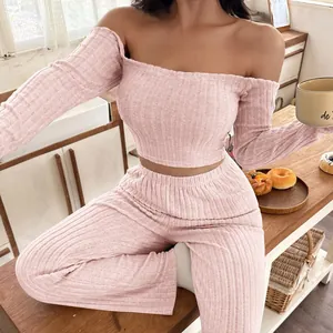 Stylish pink ribbed off-the-shoulder long sleeve top and matching pants loungewear set for women