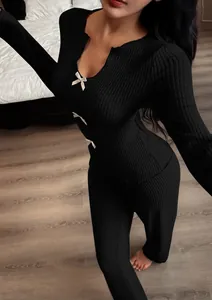 Detailed view of women's black ribbed knit pajama set with elegant bow accents