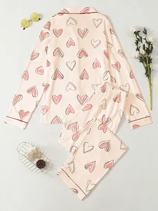 Detailed view of pink heart print pajama set featuring long sleeves and lapel collar
