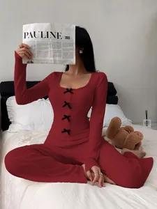 Red ribbed long sleeve loungewear set featuring chic black bows and cozy knit fabric