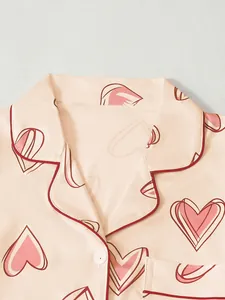 Detailed close-up showing the notched lapel and red piping of heart print pajamas