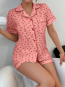 Women's pink heart print pajama set featuring short sleeves and button-down styling