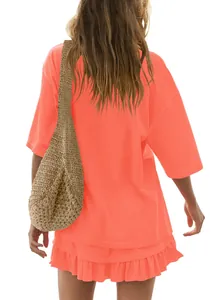 Back view of a vibrant coral orange short sleeve top and ruffled mini skirt set