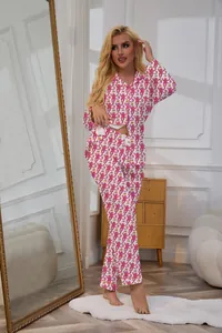 Elegant women's two-piece pajama set featuring a playful pink monkey print and long sleeves