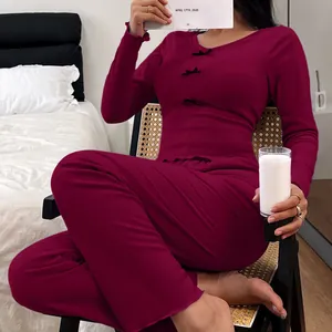 Women's burgundy ribbed long-sleeve pajamas set with cute bows in cozy bedroom