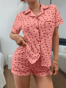 Detailed view of pink cotton women's pajama set featuring red heart print and lapel