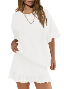 Close-up detail of a minimalist white two-piece outfit with a ruffled short skirt design.