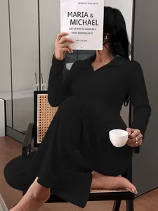 Woman wearing a black ribbed knit polo top and pants loungewear set on a chair
