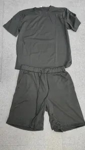 Macro view of black short sleeve t-shirt and shorts set on grey background