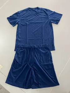 Full view of navy blue men's short-sleeve T-shirt and drawstring shorts set on gray floor