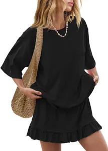 Detail showing the ruffled hem of the black mini skirt and relaxed fit T-shirt set.