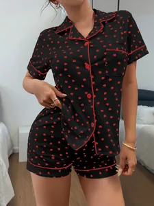 Women's black pajama set with red heart print and classic button-down collar details