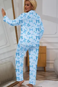 Full back view of a blonde woman wearing light blue long-sleeved pajamas with blue bow prints