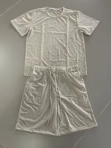 High-quality detail view of men's summer casual set including T-shirt and shorts in light grey