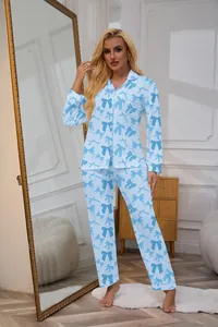 Full-length detail of women's light blue long-sleeved pajama set with navy blue bow print