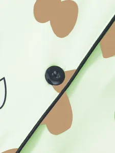 Macro detail of the black button and piping on women's heart print pajama fabric set