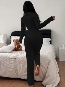 Detail view showing the back fit of a black ribbed knit polo loungewear set for women.