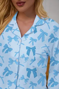 Close-up of light blue pajama top with dark blue bow pattern and lapel collar details