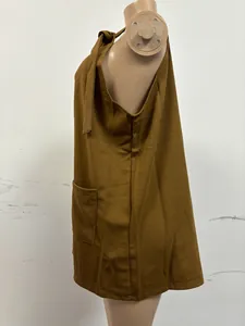 Detailed side view of a brown casual sleeveless romper jumpsuit with a pocket on mannequin