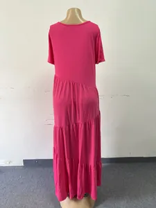 Back view of a fuchsia short-sleeve maxi dress with asymmetrical tiered ruffles.
