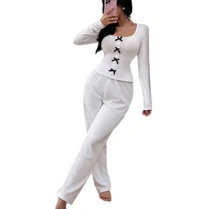 Elegant women's white ribbed knit loungewear set featuring bow accents and long sleeves