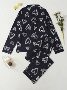 Detailed view of the elegant white heart print on the black long-sleeved pajamas