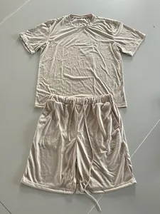 Flat lay detail showing the full beige men's casual summer set with T-shirt and shorts.