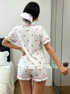 Back view of white cotton pajama set with red cherry print and red piping detail.